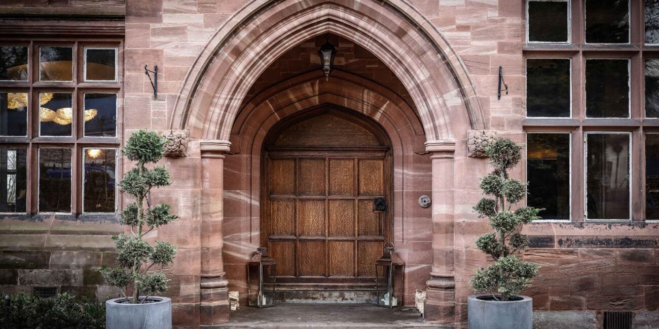 standon hall main entrance door with heritage original hardwood timber and solid red stone walls